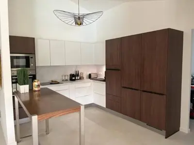 a kitchen with a table and a butterfly on the ceiling at Villa Fiori Porto Vecchio avec piscine privée in Porto-Vecchio