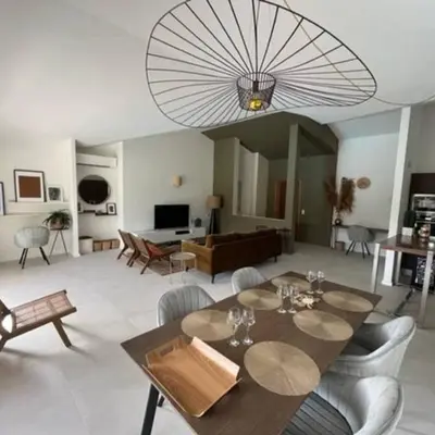 a large living room with a table and chairs at Villa Fiori Porto Vecchio avec piscine privée in Porto-Vecchio