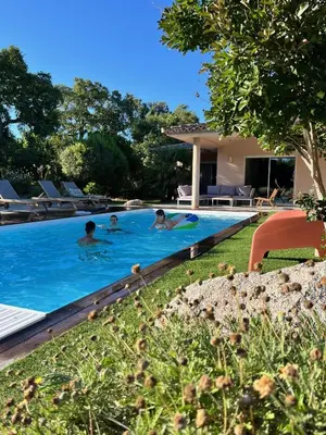 a group of people swimming in a swimming pool at Villa Fiori Porto Vecchio avec piscine privée in Porto-Vecchio