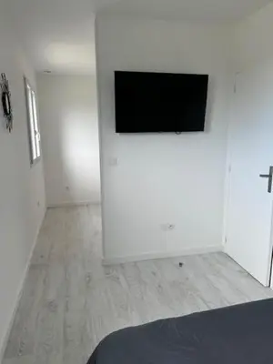 a white room with a flat screen tv on a wall at Casa San Stefanu in Olmeta-di-Tuda