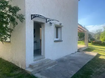a white building with a door and a window at Casa San Stefanu in Olmeta-di-Tuda