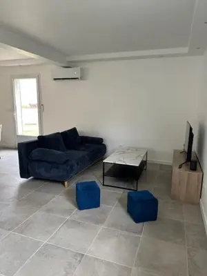 a living room with a blue couch and blue stools at Casa San Stefanu in Olmeta-di-Tuda