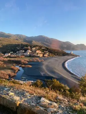 a view of a beach with houses and the water at Casa San Stefanu in Olmeta-di-Tuda