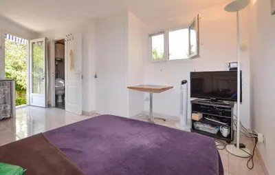 a living room with a bed and a tv at Awesome Home In Oletta in Oletta