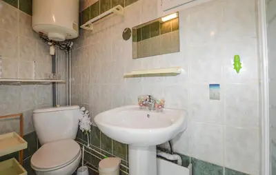 a bathroom with a toilet and a sink at Awesome Home In Oletta in Oletta