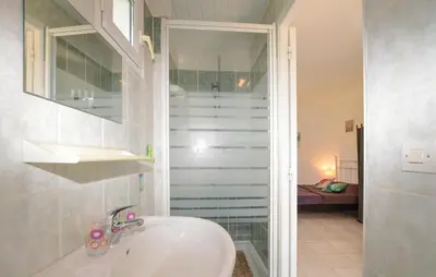 a bathroom with a sink and a walk in shower at Awesome Home In Oletta in Oletta