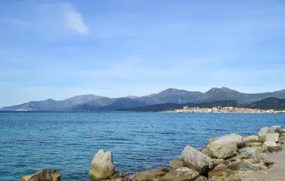 a large body of water with mountains in the background at Awesome Home In Oletta in Oletta