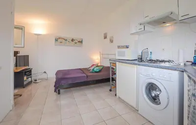 a room with a bed and a washing machine at Awesome Home In Oletta in Oletta