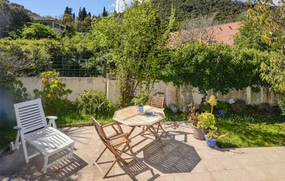 a patio with a table and chairs and a fence at Awesome Home In Oletta in Oletta