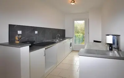 a kitchen with white cabinets and a black counter top at 1 Bedroom Awesome Home In Vignale in Vignale