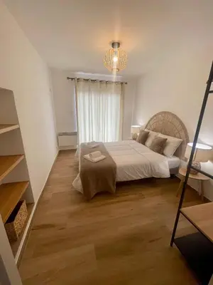 a bedroom with a large bed and a window at Petite maison de village in Bastelica