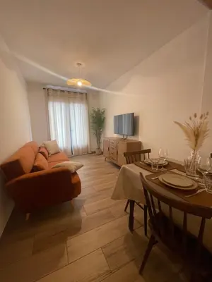 a living room with a couch and a table at Petite maison de village in Bastelica