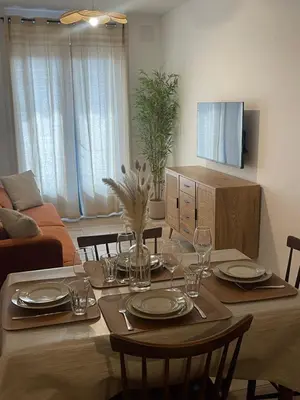 a dining room table with plates and wine glasses at Petite maison de village in Bastelica