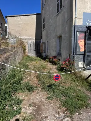a red frisbee on a string next to a building at Appartement au cœur du village in Murato