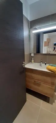 a bathroom with a sink and a mirror at Chez bigoudy in Penta-di-Casinca