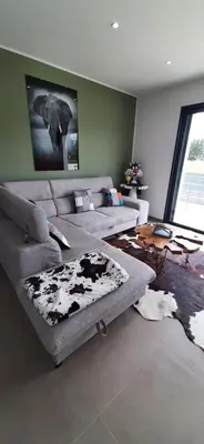 a living room with two couches and a table at Chez bigoudy in Penta-di-Casinca
