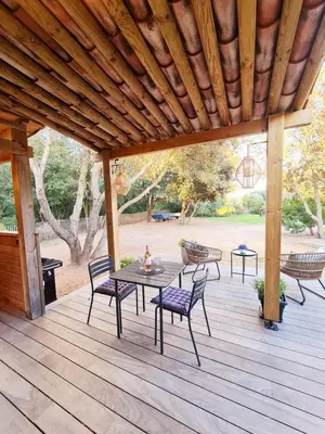 a wooden deck with a table and chairs on it at Studio à Bonifacio in Bonifacio