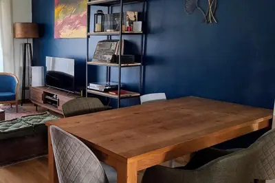 a dining room with a wooden table and chairs at Charmant cosy T3 in Ajaccio