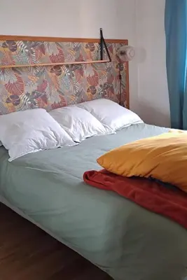 a bed with two pillows and a blanket on it at Charmant cosy T3 in Ajaccio
