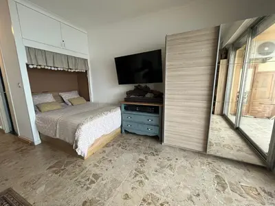a bedroom with a bed and a flat screen tv at Appartement pieds dans l eau in Ajaccio