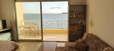 a living room with a view of the ocean at Appartement pieds dans l eau in Ajaccio