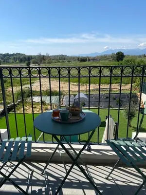 a table with a plate of food on a balcony at Casa linsia in Aléria