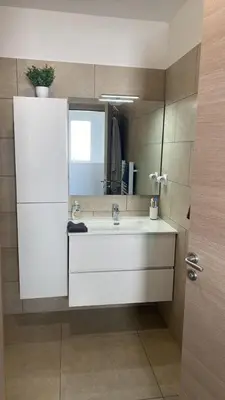 a bathroom with a white sink and a mirror at Casa linsia in Aléria