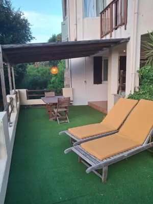 a patio with two lounge chairs and a table at Le Gîte Radica in Eccica-Suarella