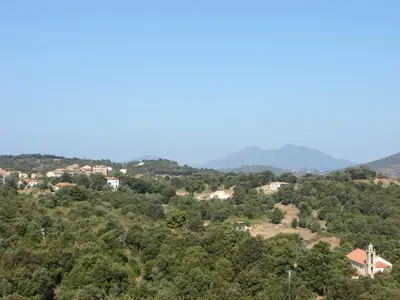 a view of a hill with houses and trees at Le Gîte Radica in Eccica-Suarella