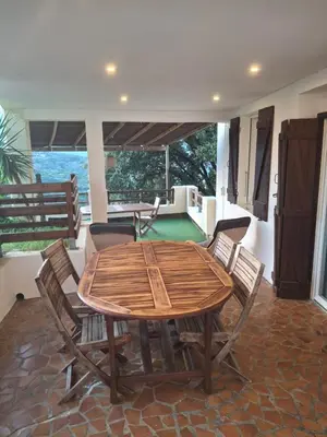 a wooden table and chairs in a room at Le Gîte Radica in Eccica-Suarella