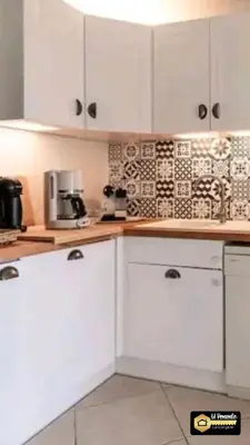 a white kitchen with white cabinets and appliances at A Bella Gaia in Cauro