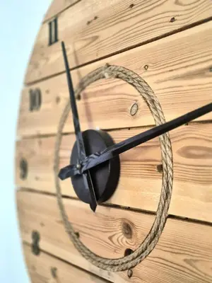 a clock on a wooden wall with a rope at A Bella Gaia in Cauro