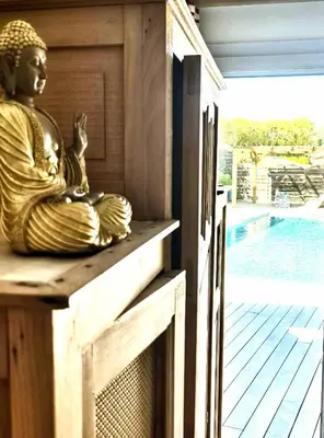 a statue of a buddha sitting on a porch at A Bella Gaia in Cauro