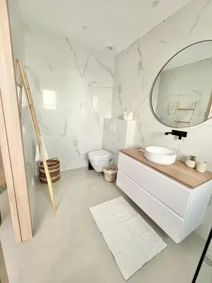 a white bathroom with a sink and a mirror at Villa vue montagne - 8 pers in Sotta
