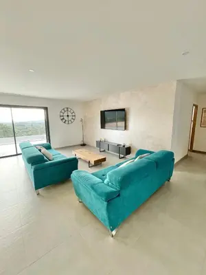 a living room with two blue couches and a table at Villa vue montagne - 8 pers in Sotta