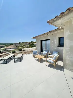 a patio with furniture and a view of the ocean at Villa vue montagne - 8 pers in Sotta