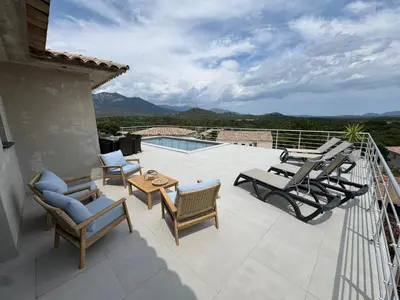 a patio with chairs and a table and a pool at Villa vue montagne - 8 pers in Sotta