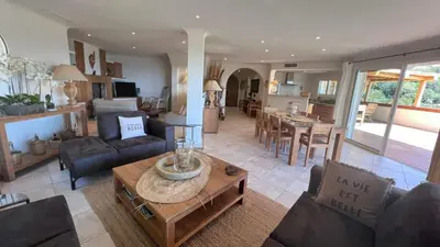a living room with a couch and a table at Secluded Villa With Sea View In Palombaggia in Porto-Vecchio