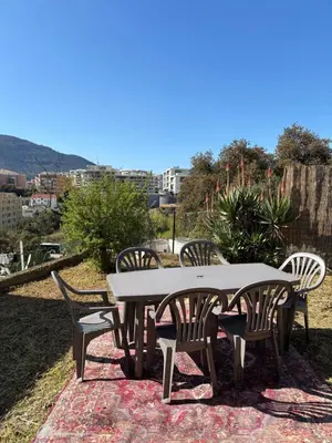 a table and chairs sitting on top of a rug at Pietralba t3 in Ajaccio
