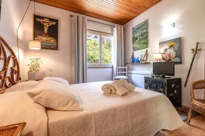 a bedroom with a bed and a window at Casa Ultima - Superbe vue proche Ajaccio in Sarrola-Carcopino
