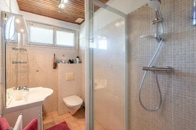 a bathroom with a shower and a toilet and a sink at Casa Ultima - Superbe vue proche Ajaccio in Sarrola-Carcopino