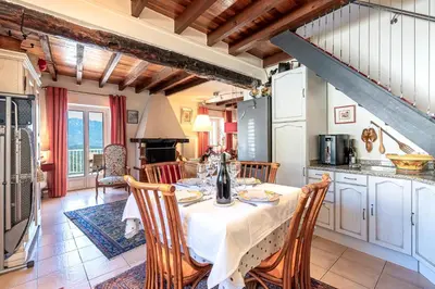 a kitchen and dining room with a table and chairs at Casa Ultima - Superbe vue proche Ajaccio in Sarrola-Carcopino