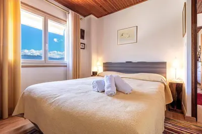 a bedroom with a bed with two towels on it at Casa Ultima - Superbe vue proche Ajaccio in Sarrola-Carcopino