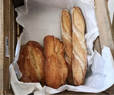 a box with three loaves of bread in it at Le Refuge Orezza in Piedicroce