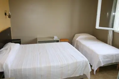 a room with two beds in a room at Le Refuge Orezza in Piedicroce