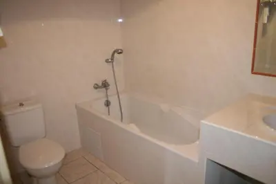 a bathroom with a toilet and a tub and a sink at Le Refuge Orezza in Piedicroce