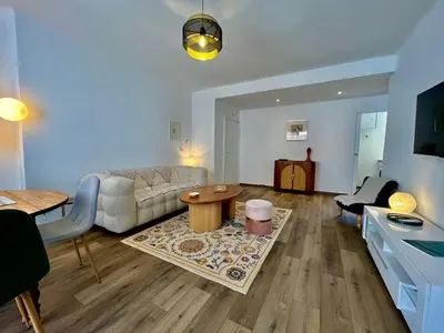a living room with a couch and a table at Charmant appartement 50 m Plage in Ajaccio