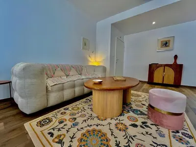 a living room with a couch and a table at Charmant appartement 50 m Plage in Ajaccio