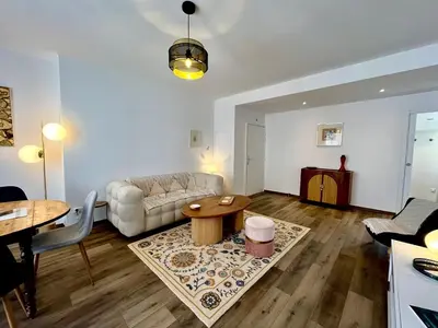 a living room with a couch and a table at Charmant appartement 50 m Plage in Ajaccio