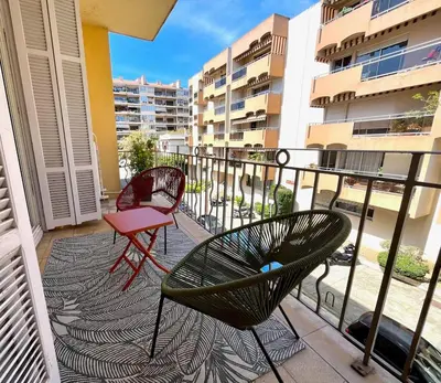 two chairs and a table on a balcony at Charmant appartement 50 m Plage in Ajaccio